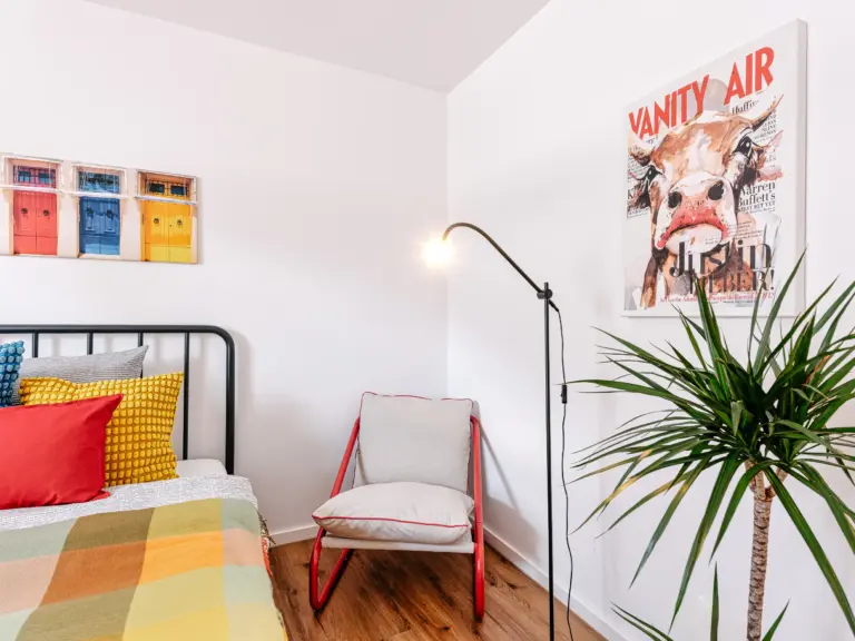 Second bedroom with queen-size bed and seating area at PEARL WHITE