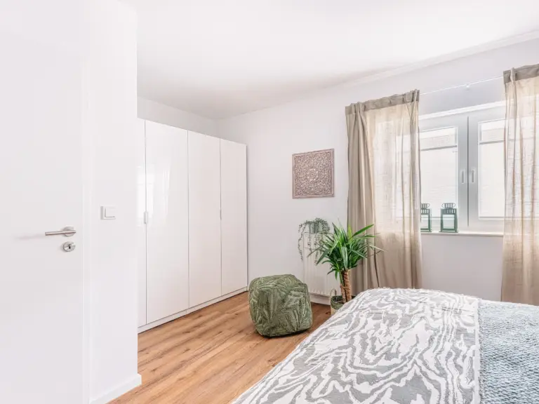 Master bedroom with king-size bed and wardrobe at PEARL WHITE