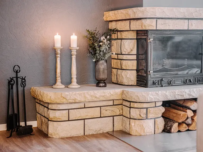 Stone fireplace with decorative candles at RUBY RED