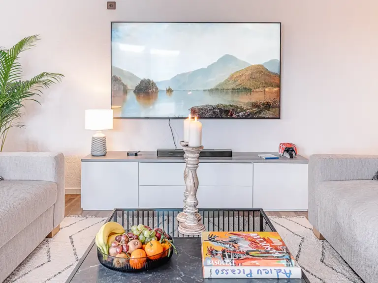 Large TV and entertainment setup in the living room at RUBY RED
