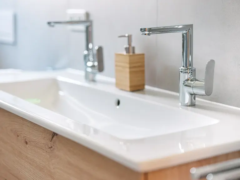 Modern bathroom vanity and sink at PEARL WHITE